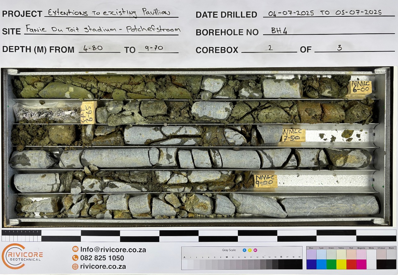 A picture of rotary drilled core in a box with a photo board
